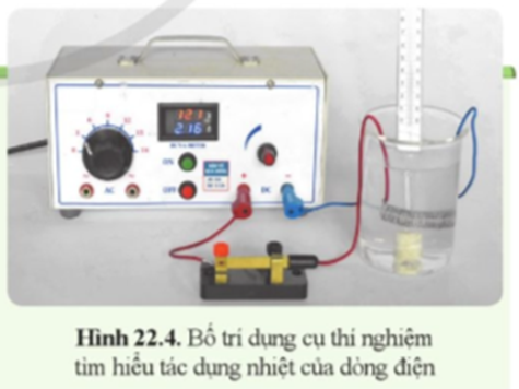 Chuẩn bị  Biến áp nguồn (loại có điện áp không đổi đến 24 V), cốc đựng nước, điện trở dạng dây quấn, nhiệt kế, công tắc, dây nối. (ảnh 1)