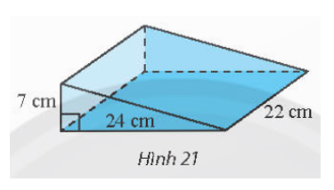 Tính thể tích cái nêm hình lăng trụ đứng có kích thước như trong Hình 21. (ảnh 1)
