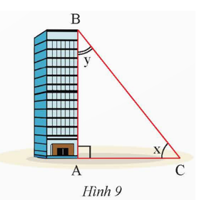 Tia nắng chiếu qua điểm B của nóc tòa nhà tạo với mặt đất một góc x và tạo với cạnh AB của tòa nhà một góc y (Hình 9) (ảnh 1)