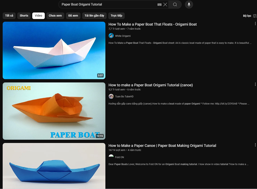 Hãy sử dụng từ khoá “Paper Boat Origami Tutorial” để tìm video hướng dẫn gấp một chiếc thuyền có hình dạng như hình bên và thực hiện theo hướng dẫn của video. (ảnh 2)