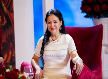 A person in a white dress sitting in a red chair
AI-generated content may be incorrect.