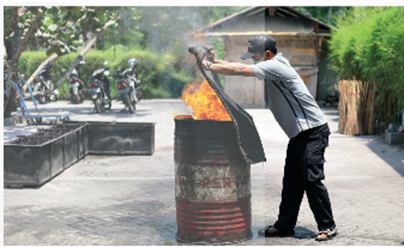 A person putting a piece of cloth on a barrel

AI-generated content may be incorrect.