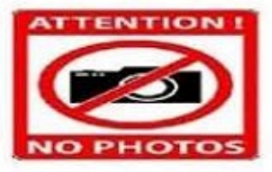 What does the sign say? A. You are allowed to take photos in this area. B. Photography is not allowed in this area. C. We don't sell cameras, so visitors can't buy any here. D. People who forget to bring cameras are not allowed to enter. (ảnh 1)