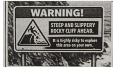 You see this sign on a rocky cliff. What does it warn tourists about? (ảnh 1)